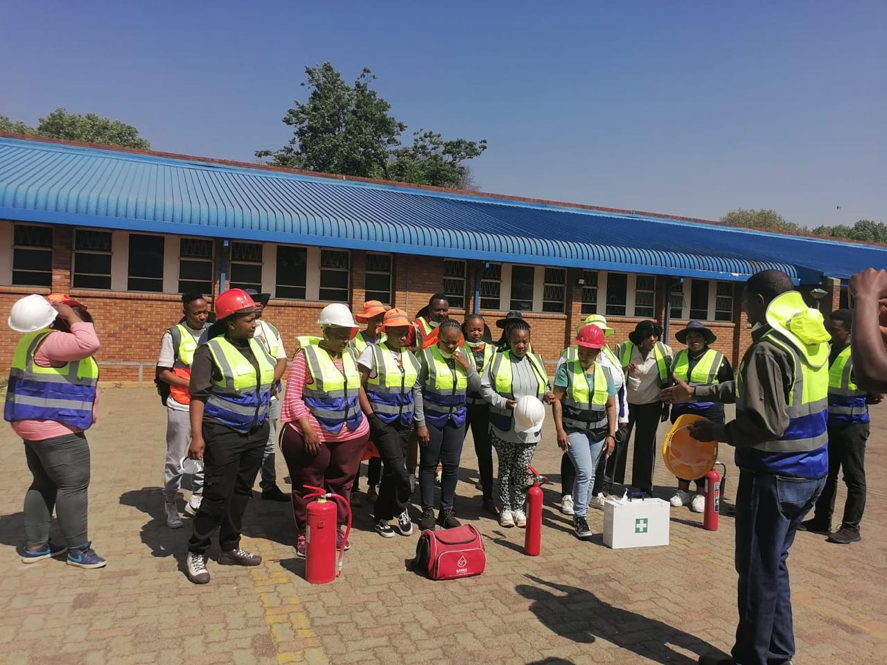 Workplace safety training group — smiling and celebratory